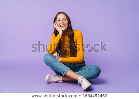 Foto stock: Photo Of Smiling Cute Brunette Girl Sitting And Posing