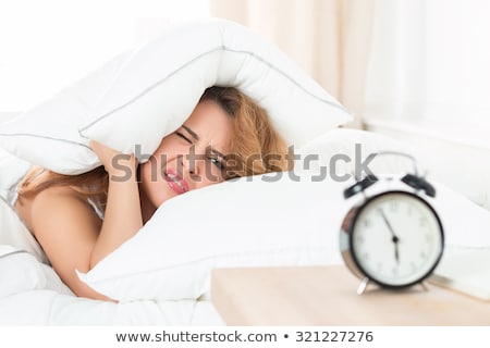 Foto d'archivio: Beautiful Young Woman Sleeping In Bed Trying To Wake Up With Ala