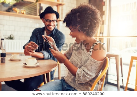 ストックフォト: Cheerful Young Couple Sitting At The Cafe Table