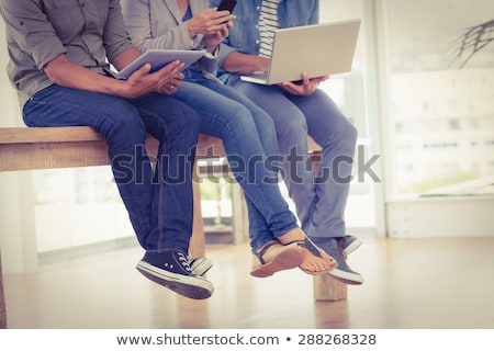 Stock fotó: Woman Showing Tablet Pc To Creative Team At Office