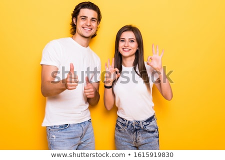 Stockfoto: Happy Cute Young Woman Posing Isolated Over Yellow Background Holding Gift Box Present