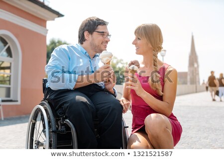 Сток-фото: Disabled Man And His Friend Having Ice Cream In Town