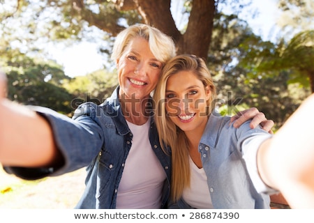 Сток-фото: Grandmother And Granddaughter Take Selfie At Park
