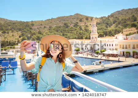 Foto stock: Excited Female Tourist Making Self Portrait In Front Of The Waterfall Woman Having A Great Vacation
