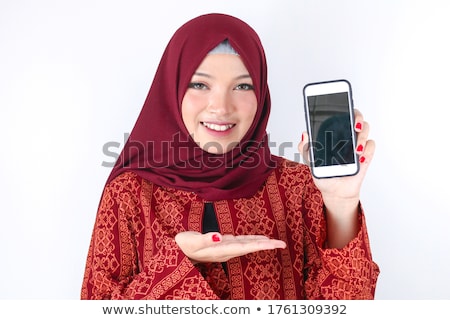 Stock photo: Young Asian Islam Woman Is Smiling Showing Smartphone Standing O