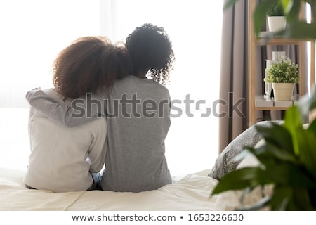 Stockfoto: Back View Of Two Girl Which Holding Hands