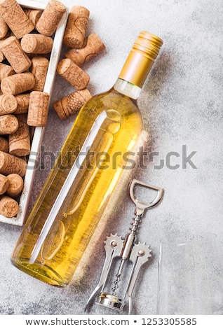 Stok fotoğraf: Glass Of White Wine With Box Of Corks And Crkscrew Opener On Stone Kitchen Table Background Top Vie