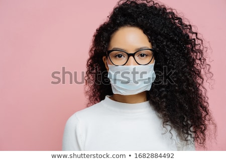 Stockfoto: Covid 19 Infectious Virus Close Up Shot Of Young Woman With Curly Bushy Hair Wears Transparent Gl