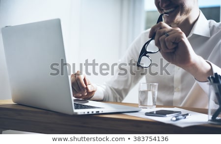ストックフォト: Closeup Of A Young Smiling Business Man Sitting At His Office Ag