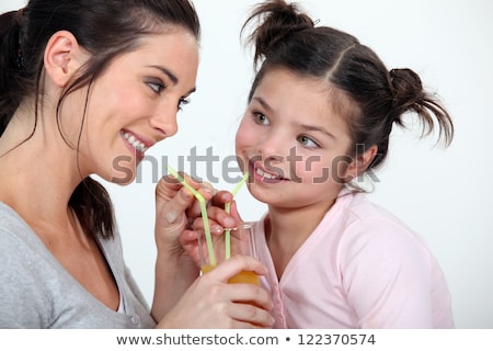 Zdjęcia stock: Woman Sharing A Glass Of Juice With Her Little Sister