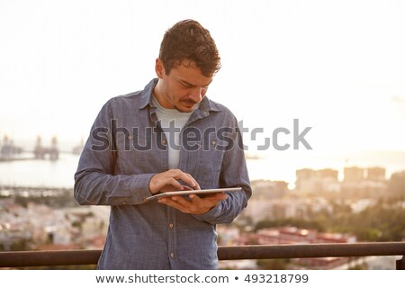 Stock photo: Casual Man Looks To His Side With Sunset Behind