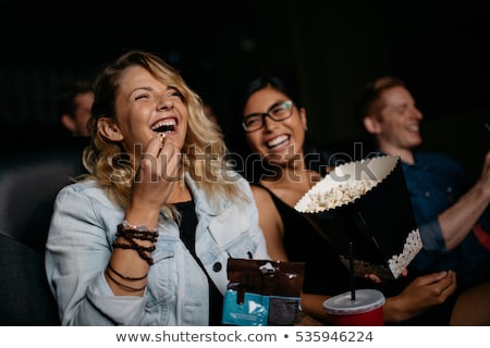 Stock photo: Friends Watching Movie In Theatre