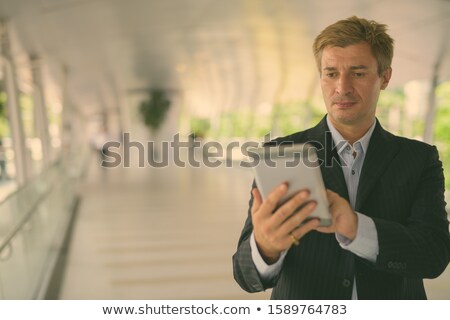 [[stock_photo]]: Businessman Relaxing At The Footbridge In Bangkok Thailand