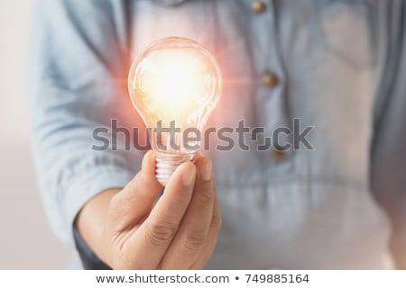 Stock photo: Businesswoman Holding Illuminated Light Bulb