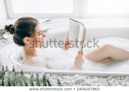 Foto stock: Happy Young Woman Relaxing In Bathtub