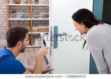 Foto stock: Woman Locksmith Repairing A Lock