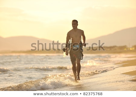 Stock photo: Portrait Of A Young Kitsurf Man At Beach On Sunset