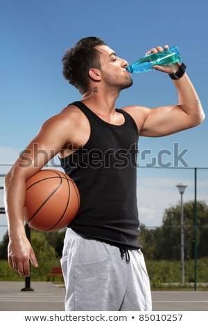 Stock photo: Man With A Basketball And Bottle Of Water