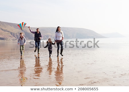 Stockfoto: Family Having Fun On Winter Beach