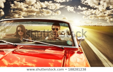 Stock fotó: Two Adults In A Sports Car