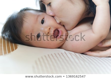 Stockfoto: Close Up Of Happy Mother Kissing Baby Son At Home