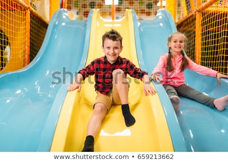 Foto stock: The Boy Rides With An Inflatable Slide