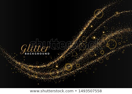 Stock foto: Glitterting Dust Golden Trail On Black Background