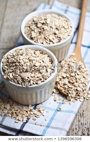 Foto stock: Oat Flakes In Ceramic Bowl On Linen Napkin Golden Wheat Ears On