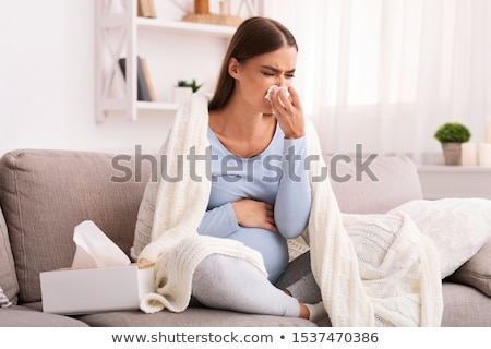 [[stock_photo]]: Sick Woman With Fever On Sofa