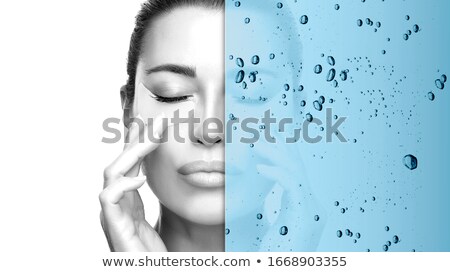 Zdjęcia stock: Woman With Eyes Shut Applying Foundation