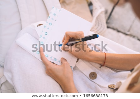 Stockfoto: Young Woman Writing Postcards