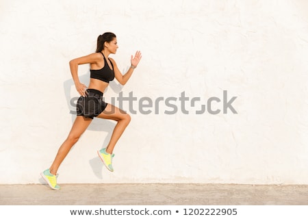 [[stock_photo]]: Full Length Image Of Energetic Woman 20s In Sportswear Working O