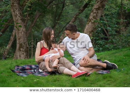 Сток-фото: Woman With Daughter Sitting On Blanket In Park