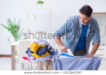 ストックフォト: Young Handsome Man Doing Housework