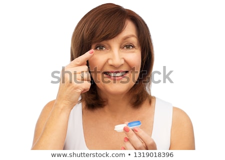 Stok fotoğraf: Happy Senior Woman Applying Contact Lenses