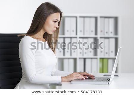 Stockfoto: Side View Of Pretty Young Caucasian Businesswoman Sitting On The Sofa And Looking Away In Modern Off