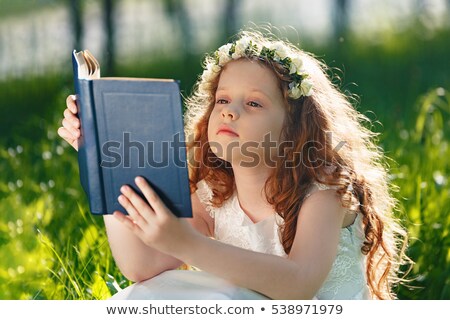 Foto stock: Beautiful Redhead Reading A Bible