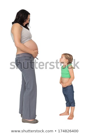 Stock fotó: Little Girl Looking Up At Her Mothers Baby Bump