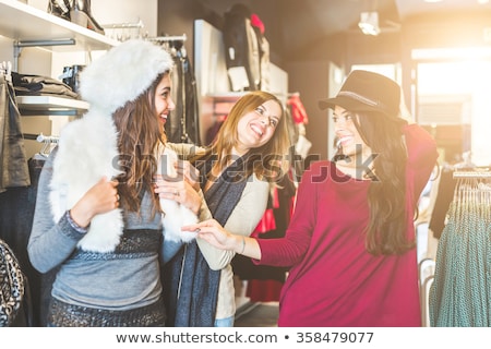 Stockfoto: Young Woman Shopping In A Fashion Store Trying On Some Clothes