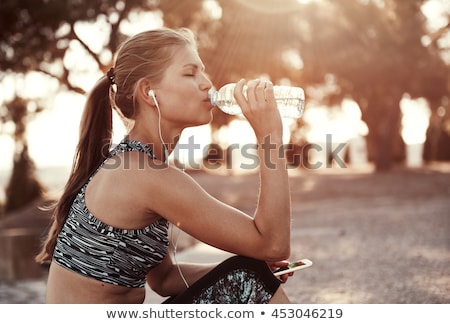 Сток-фото: Fitness Woman In Park Listening Music With Headphones