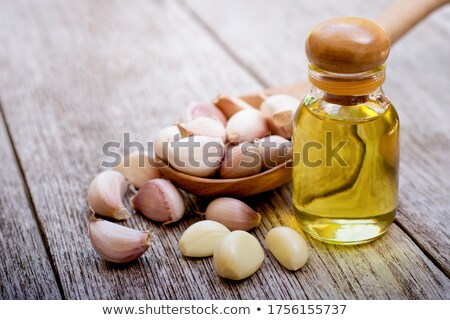 Stock photo: Garlic With Essential Oil In A Bottle