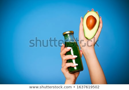 Stock fotó: Close Up Of Young Girl Holding Avocado And Green Smoothie