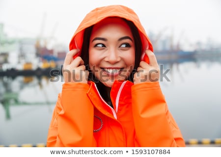 Stock fotó: Smiling Attractive Young Asian Woman Wearing Raincoat