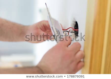 Foto d'archivio: Electrician Wiring A Light Switch