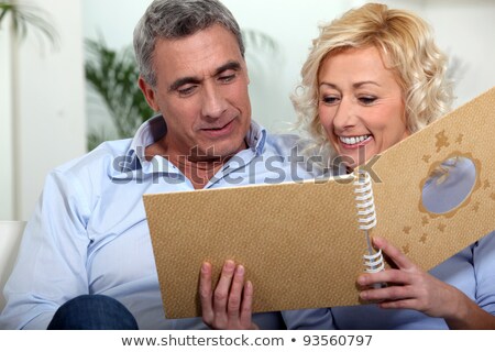 Foto d'archivio: Mature Couple Looking At Photo Album