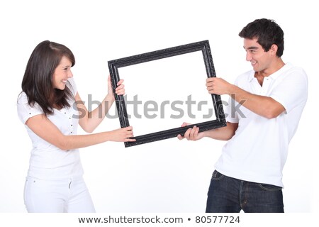 Stok fotoğraf: Couple Fighting Over Blank Picture Frame
