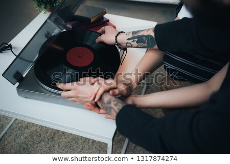 Stock photo: Young Couple Putting On A Vinyl Record