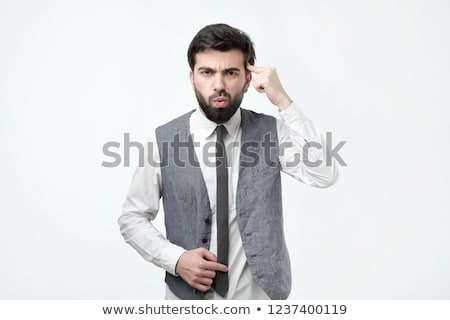Stockfoto: Angry Man Gesturing With His Finger Against Temple