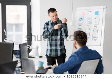 Foto stock: Man Showing Smart Watch To Creative Team At Office