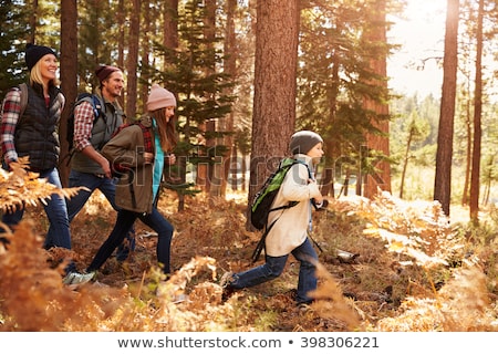 ストックフォト: Family With Backpacks Hiking Or Walking In Woods